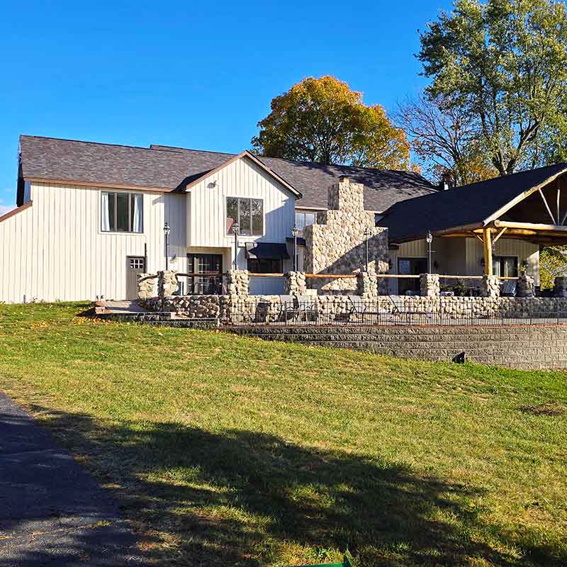 Stone Bridge Farm Close-up view of the main house and cocktail area